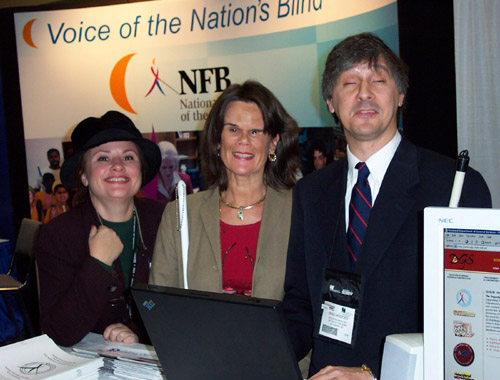 Standing at the NFB Technology Showcase booth are Susan Casey, Department of General Services communications deputy director; Betsy Zaborowski; and Brad Hodges, member of the staff of the NFB's International Braille and Technology Center for the Blind.