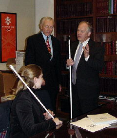 Senator Orrin G. Hatch listens to Ron Gardner, president of the NFB of Utah, and a colleague.