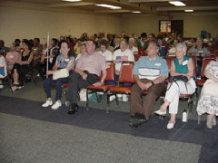 A large audience of seniors listens closely to a presentation of the seniors division's 2002 meeting.