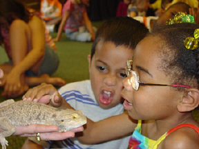 Ricardo Garcia (New York) and Alicia Jones (Kentucky) meet a lizard during the NFB Camp visit to the Louisville Zoo.