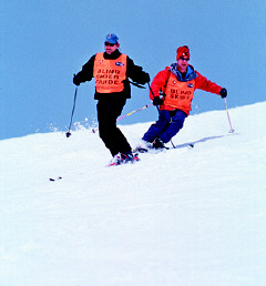 Foresight founder and president, Mark Davis (right), and his guide ski downhill.