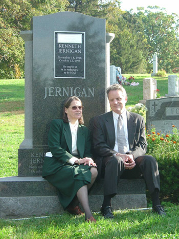 Mary Ellen Jernigan and Marc Maurer sit talking on Dr. Jernigan's monument following the memorial mass.