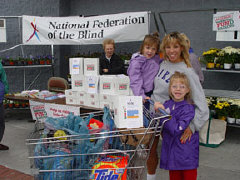 A  mother and her children support the NFB with their purchase of a box of Krispy Kreme doughnuts at a local Wal-Mart store information table.