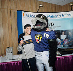 Nijat Ashrafzada, son of NFB merchants division president Kevan Worley and his wife Bridgit, enjoys meeting Edgar, one of the Ravens football team's mascots, Allen and Poe were not able to join us.