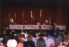 The general session dais with sponsor logos displayed across the front side.