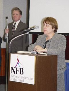 Joanne Wilson, commisioner of the Rehabilitation Services Administration, delivers the keynote address for the April 8 conference session.   President Maurer stands behind her.