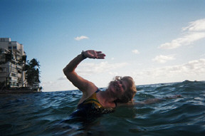 Katie Keim swims close to shore in the Pacific off Waikiki Beach, not far from Diamond Head Crater.