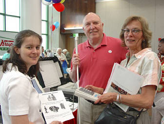 Pictured here are Jaimie Jacobs, election reform deputy director of the Maryland Board of Elections, showing Jim Courtney of Monkton, Maryland, how to use the new Diebold accessible voting machine.   Jim's daughter Holly Snyder of Pennsylvania examines the keypad.
