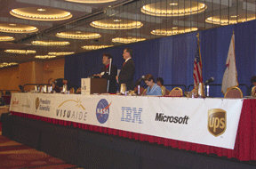 The general session dais of the 64th NFB annual convention with sponsor logos displayed across the front side.  Special thanks go to convention sponsors (left to right) Marriott Worldwide Reservations, Freedom Scientific,VisuAide, IBM, Microsoft, and UPS and partner NASA