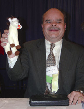 Kevan Worley, president of the National Association of Blind Merchants, proudly displays the PAC Mule.