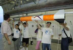 Action Reaction team makes sure that the rocket is properly loaded onto the launcher.