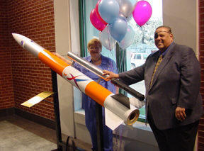 Jackie and Charlie Brown (Virginia) inspect a sounding rocket, like the one launched by Rocket On! campers last summer.   It is on display in the first-floor atium of the Jernigan Institute,