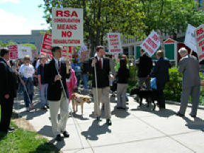 Probably walking a picket line doesn't make much sense to guide dogs, but they followed orders anyway