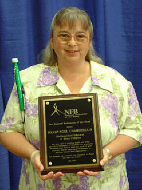 Merry-Noel Chamberlain displays her Distinguished Educator plaque.