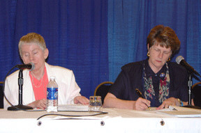 Sharon Maneki, Resolutions Committee chair, and Sharon Omvig, committee secretary, are pictured seated on stage Friday afternoon.