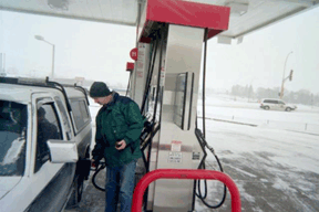 Robert Moore fills the gas tank on his pickup truck.
