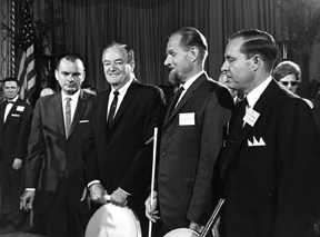 Left to right Russell Kletzing, NFB president; Hubert Humphrey, vice president of the United States; Dr. tenBroek; and Kenneth Jernigan pose at the 1965 NFB national convention banquet.