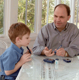 JonCarlos watches his father, Tom, test his blood sugar.