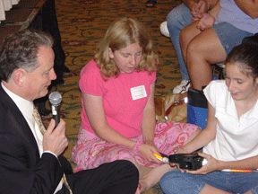 NFB President Maurer seated on the floor with the children