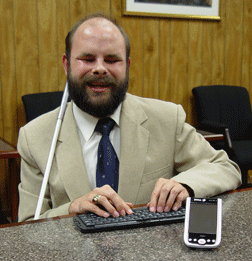 Mike Tindell is pictured here with the Mobile Speak Pocket 9.
