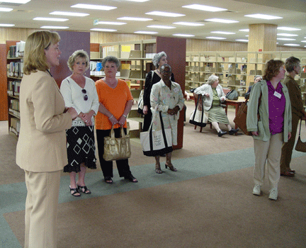 tenBroek Librarian Dawn Stitzel shows the library to a tour group.