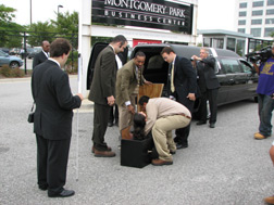Marco Carranza places his wife Rosy�s body in a coffin with pall bearers standing around, waiting to put the casket in a hearse.