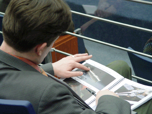 A reporter examines one of the tactile photos in Touch the Invisible Sky.
