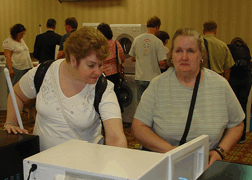 Mindy Jacobsen and Joyce Carrico examine an accessible microwave oven.