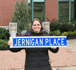 Mary Ellen Jernigan displays the sign before it is mounted.