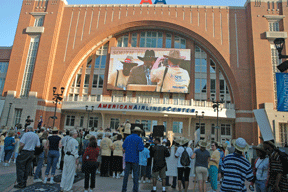 Federationists stream into Victory Plaza, having completed the first half of the march. On a giant screen in the background, Kevan Worley, master of ceremonies for the March rally, can be seen welcoming the crowd and preparing for the program.