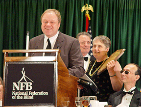 Ramona Walhof holds the tenBroek plaque while Gary Wunder prepares to address the audience.