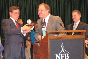 Jim Fruchterman examines the Bolotin Award while Gary Wunder (center) and Marc Maurer (right) look on.