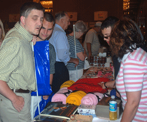 Federationists crowd around the NOPBC table in the exhibit hall to examine the division's merchandise.
