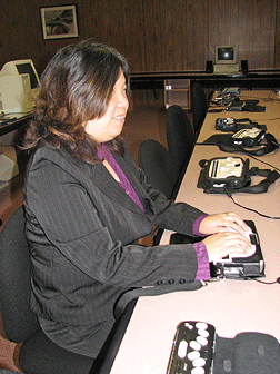 Director of Access Technology Anne Taylor using the Braille Sense