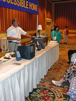 A speaker demonstrates equipment at an IBTC seminar.