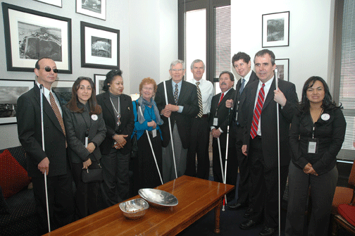 Seated around a table in New Mexico Senator Jeff Bingaman’s office, left to right, are Fred Schroeder, Joni Martinez, Wanda Briggs, NFB of New Mexico President Christine Hall, Arthur Schreiber, Senator Bingaman, Ray Marshall, Wesley Peters, James McCarthy, and Claudia Martinez.