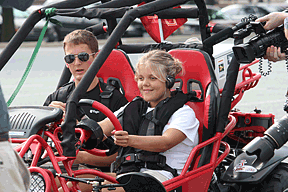 Addison Hugen, IA, drives the Virginia Tech University prototype vehicle, accompanied by Greg Jannaman from the VTU Blind Driver Challenge team.