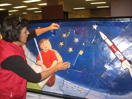 Ann Cunningham checks the fit for the last puzzle piece before gluing it in place.