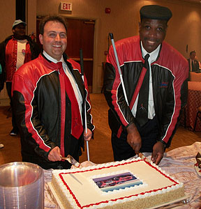 Mark Riccobono and Anil Lewis cut the cake at the reception.