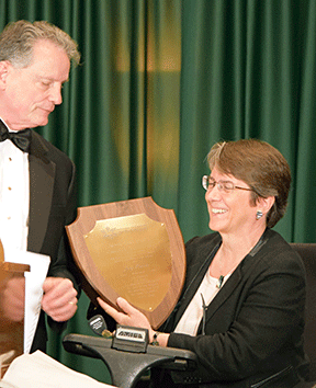 Judy Brewer accepting Newel Perry Award from Dr. Maurer