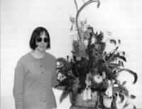 Diane Johnson displays one of her floral arrangements