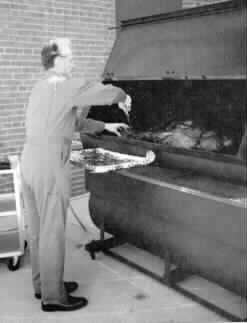 President Maurer superintending smoker for Thanksgiving turkey.