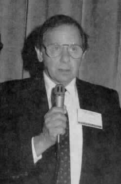Photo of Marvin Sandler holding a microphone.