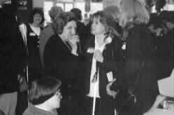 Image shows Helen Thomas chatting with guests.