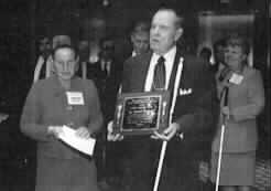 The photo is of Dr. Jernigan holding the Award; Jamie Hilton is at his right. 