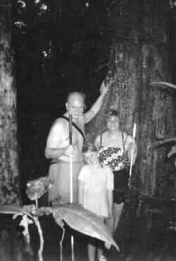 The Yeager family stands beside a huge tree. Tracy is between her parents.]