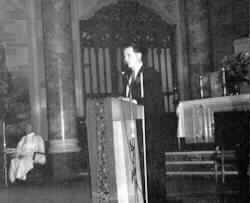 Picture of Dr. Maurer at the Podium of the church.