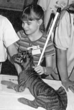 Nikki Zimmerman pictured
with a young cougar.