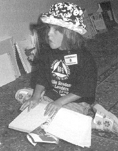 Photo of Macy McClain reading Braille