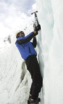 Erik Weihenmayer uses his ice pick to grip the ice as he climbs.